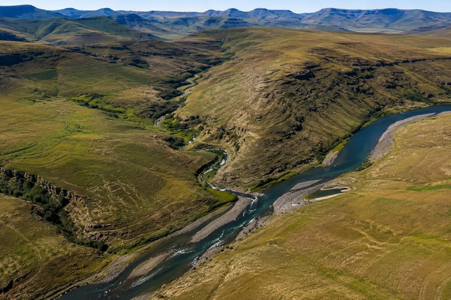 Natural highland valley at the Polihali Dam project area in Lesotho, showing the rugged mountain landscape and river corridor that form the foundation of the Lesotho Highlands Water Project Phase II.
