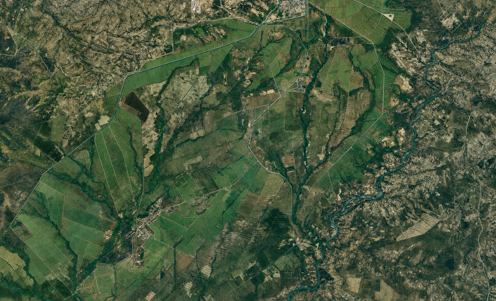 Caption:
Satellite view of the Tana-Beles irrigation and sugar-development command area in northwestern Ethiopia, showing organized agricultural fields, canal alignments, drainage corridors, and the wider Beles River landscape that supports large-scale irrigation development.
